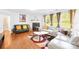 Spacious living room with hardwood floors, fireplace, comfortable seating, and large windows offering ample light at 6222 Ohaus Ct # 59, Charlotte, NC 28216