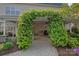 Charming patio with a vine-covered pergola and stone pavers at 642 Vega Nw St, Concord, NC 28027