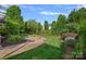 Backyard with manicured lawn and a stone fire pit, perfect for entertaining at 642 Vega Nw St, Concord, NC 28027