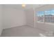 Bright bedroom featuring a large window and neutral carpeting at 642 Vega Nw St, Concord, NC 28027