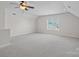 Large bonus room featuring a ceiling fan and neutral carpet at 642 Vega Nw St, Concord, NC 28027