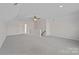 Large bonus room featuring a ceiling fan and neutral carpet at 642 Vega Nw St, Concord, NC 28027