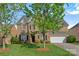 Traditional brick home featuring manicured lawn and a two-car garage at 642 Vega Nw St, Concord, NC 28027