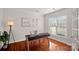 Dedicated home office space featuring hardwood floors, a large window, and a modern desk at 642 Vega Nw St, Concord, NC 28027