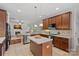 Well-appointed kitchen with island, stainless appliances, and open view to the living room at 642 Vega Nw St, Concord, NC 28027