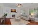 Cozy living room with fireplace, plush sofa, and multiple windows offering natural light at 642 Vega Nw St, Concord, NC 28027
