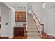 Carpeted staircase with white railings and wooden banister, next to built-in cabinetry at 642 Vega Nw St, Concord, NC 28027