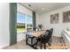 Cozy dining area with a wooden table, black chairs, and a large window with green curtains at 6455 Honor Ave, Midland, NC 28107