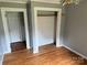 This bedroom features wood floors, closet, and entry doors at 6482 Taylorsville E Hwy, Hiddenite, NC 28636