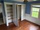 A bright bedroom with blue walls and ample closet space at 6482 Taylorsville E Hwy, Hiddenite, NC 28636