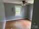 Bedroom with hardwood flooring and fan light fixture at 6482 Taylorsville E Hwy, Hiddenite, NC 28636