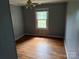Bedroom featuring wood floors, a window, and ceiling fan at 6482 Taylorsville E Hwy, Hiddenite, NC 28636