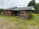 Brick home featuring a covered carport, small windows, and a spacious backyard at 6482 Taylorsville E Hwy, Hiddenite, NC 28636