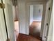 Hallway leading to multiple rooms, with hardwood floors at 6482 Taylorsville E Hwy, Hiddenite, NC 28636