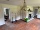 Open-concept living area with wood floors, a fireplace, and an antique chandelier at 6482 Taylorsville E Hwy, Hiddenite, NC 28636