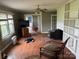 Bright living area with hardwood floors, a brick fireplace, and natural lighting at 6482 Taylorsville E Hwy, Hiddenite, NC 28636