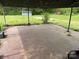 Covered outdoor slab patio next to storage shed surrounded by grass and trees at 6482 Taylorsville E Hwy, Hiddenite, NC 28636
