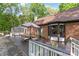 A beautiful brick home features a large, wooden back deck perfect for outdoor dining and entertaining at 6617 Wannamaker Ln, Charlotte, NC 28226