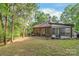 Backyard view showcasing the lush greenery and mature trees surrounding the charming home at 6617 Wannamaker Ln, Charlotte, NC 28226
