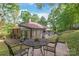 Charming backyard featuring a lush green lawn, mature trees, and a patio area with outdoor seating at 6617 Wannamaker Ln, Charlotte, NC 28226