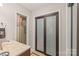 Bathroom with shower and frosted glass sliding doors at 6617 Wannamaker Ln, Charlotte, NC 28226
