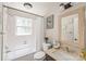 Traditional bathroom featuring a tub, shower combo, and framed mirror at 6617 Wannamaker Ln, Charlotte, NC 28226