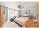 Comfortable bedroom with bay window, ceiling fan, and soft natural lighting at 6617 Wannamaker Ln, Charlotte, NC 28226