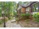 Brick home with front entrance, garden bed and retaining wall with mature plantings at 6617 Wannamaker Ln, Charlotte, NC 28226