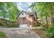 Side view of a brick home with a garage and ample parking space in the driveway at 6617 Wannamaker Ln, Charlotte, NC 28226