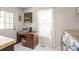 Laundry room with a window, utility sink, and storage at 6617 Wannamaker Ln, Charlotte, NC 28226
