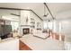Bright living room with fireplace, vaulted ceiling, ceiling fan, and an open floor plan at 6617 Wannamaker Ln, Charlotte, NC 28226