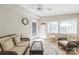Open sunroom with neutral furnishings, white brick wall, and colorful rug at 6617 Wannamaker Ln, Charlotte, NC 28226