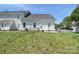 A grass backyard behind a white vinyl sided home at 6631 Vlosi Dr, Charlotte, NC 28226
