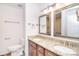 Bathroom with a double sink vanity, granite countertops, and large mirrors with decorative frames at 6631 Vlosi Dr, Charlotte, NC 28226