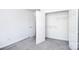 A bedroom with gray carpet, a door to the closet, and white walls at 6631 Vlosi Dr, Charlotte, NC 28226