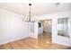 Dining area with hardwood floors and modern lighting, with views into the living room at 6631 Vlosi Dr, Charlotte, NC 28226