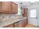 Updated kitchen with stainless steel appliances, granite countertops, and natural wood cabinets at 6631 Vlosi Dr, Charlotte, NC 28226