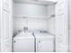 Bright laundry room featuring a side by side washer and dryer, and overhead storage at 6631 Vlosi Dr, Charlotte, NC 28226