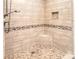 Custom shower stall featuring beautiful tile work, a built-in seat, and shower niche at 6631 Vlosi Dr, Charlotte, NC 28226