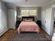 Comfortable bedroom boasts hardwood floors, large bed, and a big window at 709 Myrtle Dr, Rock Hill, SC 29730