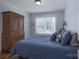 Comfortable bedroom boasts a large bed with blue bedding, hardwood floors, and window at 709 Myrtle Dr, Rock Hill, SC 29730