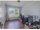 Bedroom with hardwood floors, large window, and overflowing with belongings at 709 Myrtle Dr, Rock Hill, SC 29730