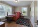 Cozy bedroom features a wooden bed frame, colorful rug, and a large window at 709 Myrtle Dr, Rock Hill, SC 29730