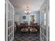 Elegant dining room with a chandelier, light blue walls, and view to another room through glass paneled doors at 709 Myrtle Dr, Rock Hill, SC 29730