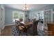 Dining room features an elegant chandelier, a large table, and a view to the living room at 709 Myrtle Dr, Rock Hill, SC 29730