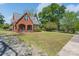 Traditional brick home with a cozy front porch, complemented by a lush green lawn and mature trees at 709 Myrtle Dr, Rock Hill, SC 29730