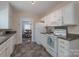 Functional kitchen with white cabinets, contrasting countertops, and a view into the elegant dining room at 709 Myrtle Dr, Rock Hill, SC 29730