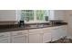 Kitchen with a double sink and white cabinets and neutral color countertops at 709 Myrtle Dr, Rock Hill, SC 29730