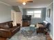 Cozy living room boasts hardwood floors, blue rug, comfortable couches and lots of light at 709 Myrtle Dr, Rock Hill, SC 29730