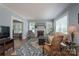 Comfortable living room featuring a brick fireplace, light blue walls, and hardwood floors at 709 Myrtle Dr, Rock Hill, SC 29730